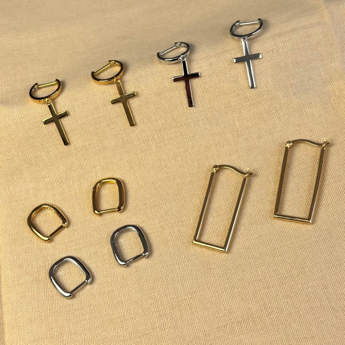 gold earrings on a marble table